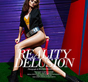 Brunette model with big, voluminous waves on a magazine cover shoot, seated against a purple striped wall